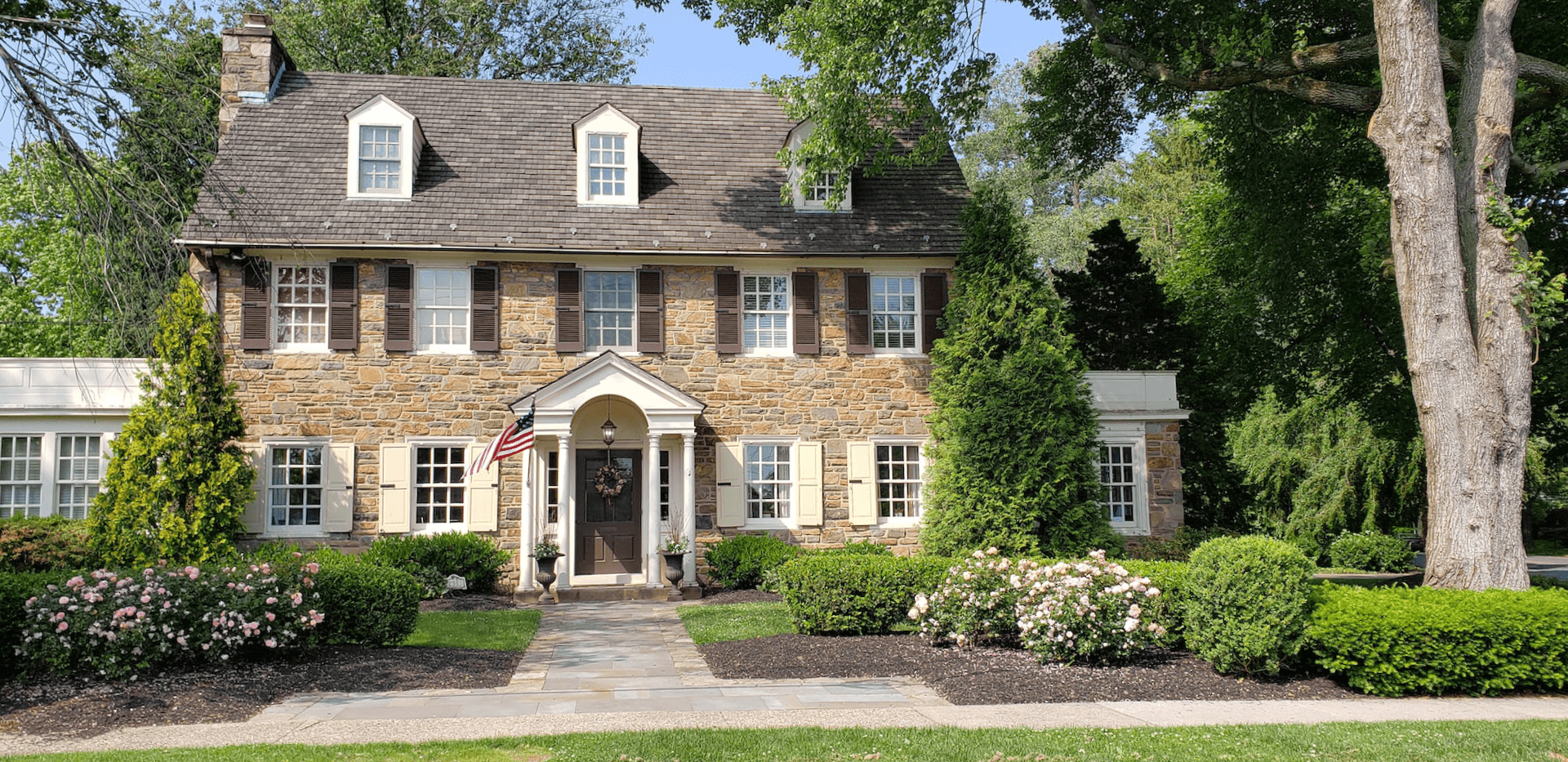 Charming colonial house style residence with a slate walkway