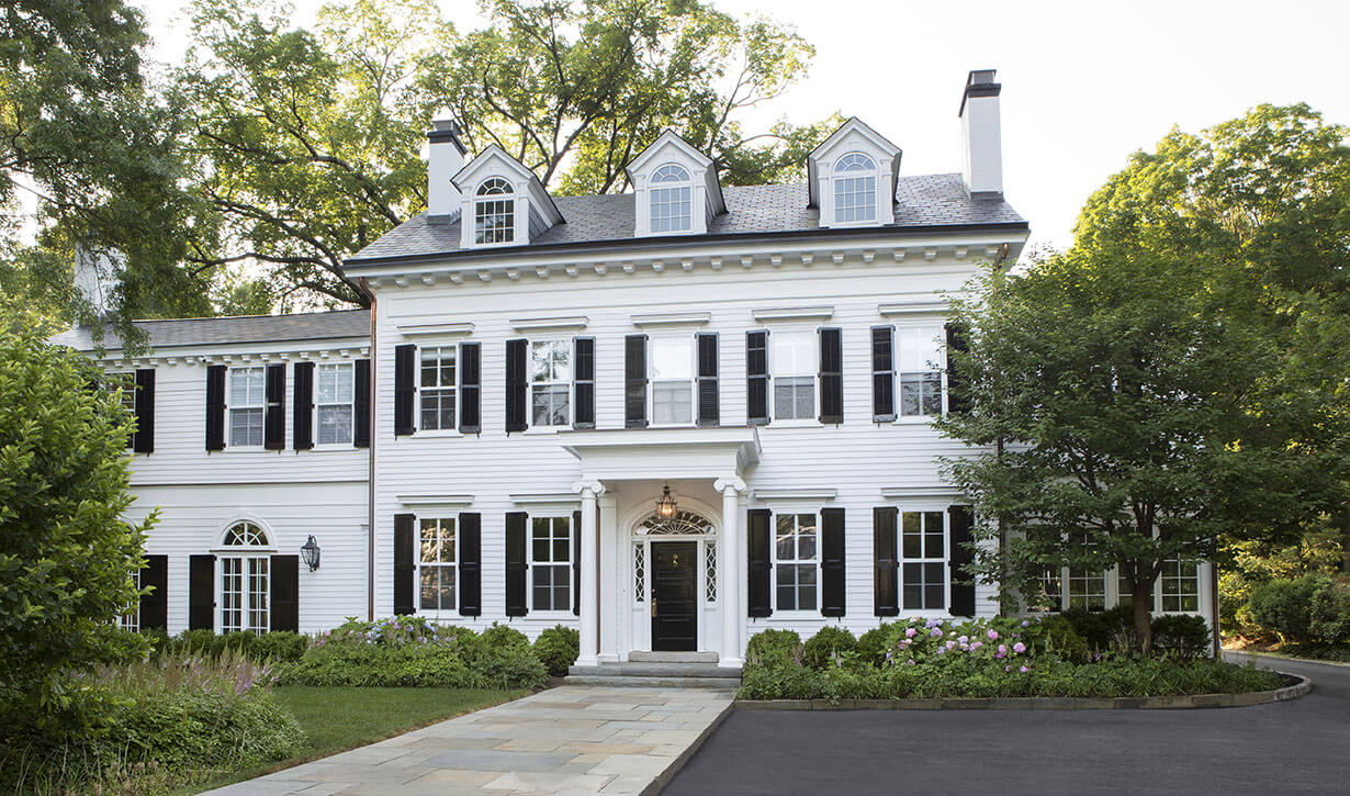 Elegant white colonial house style with black shutters